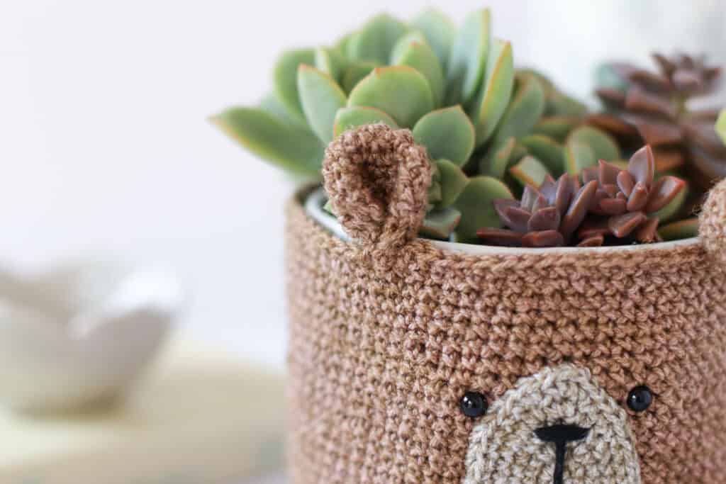 How to photograph crochet A close up of a crocheted teddy bear planter cover