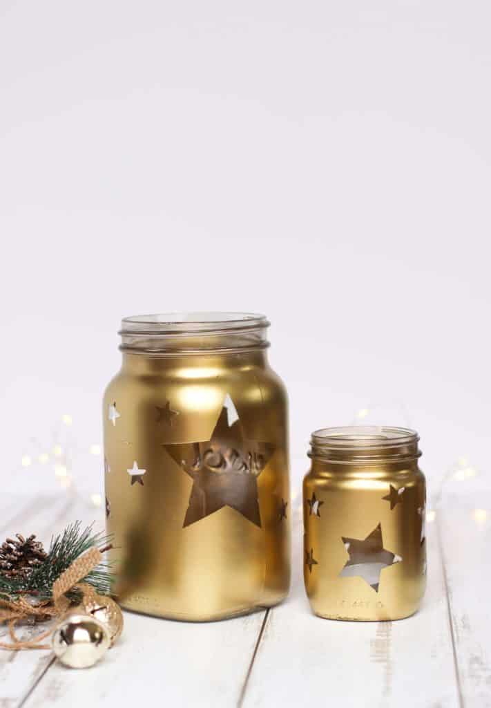 Gold jars with stars and tea light candles. Christmas decor.