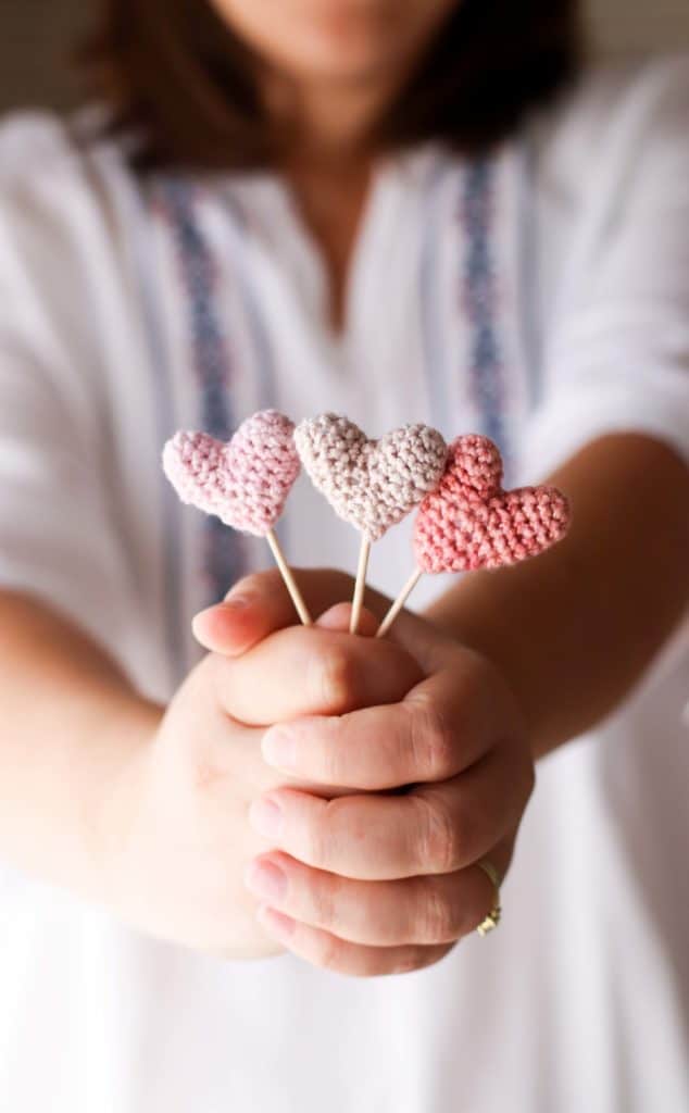 three small pink crocheted hearts