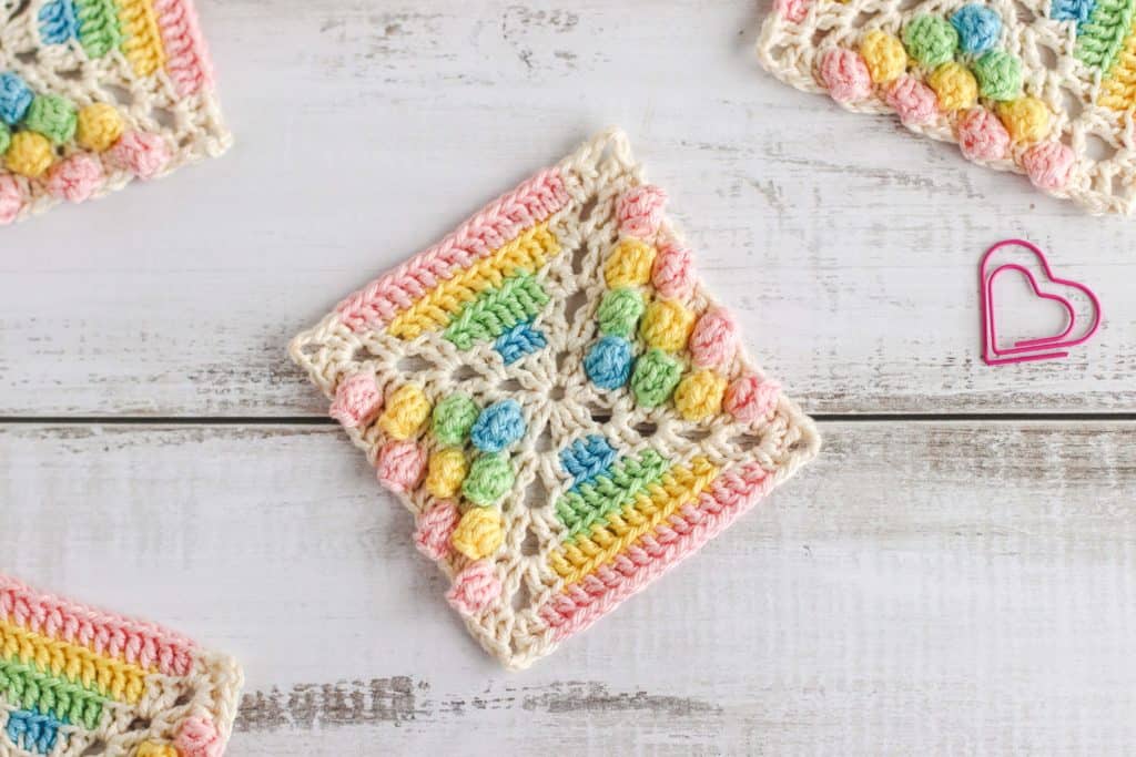 crocheted granny square using crochet cotton in pink, yellow, green, blue and cream