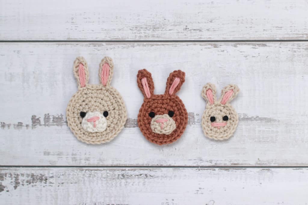 three crochetbunny appliques on a textured background.