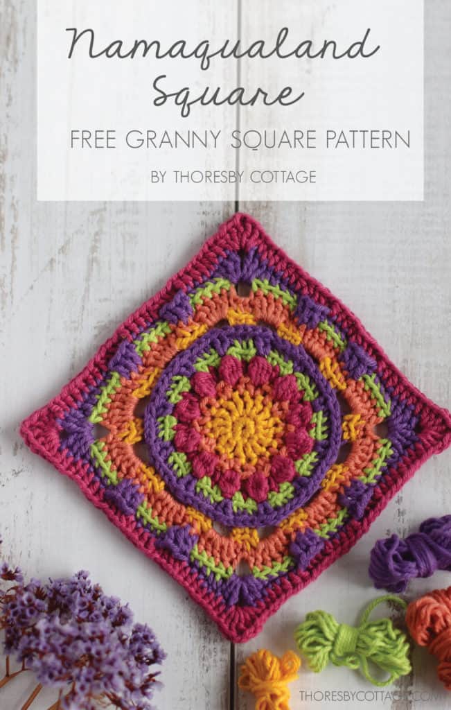 Brightly colored crochet granny square on a textured wooden background