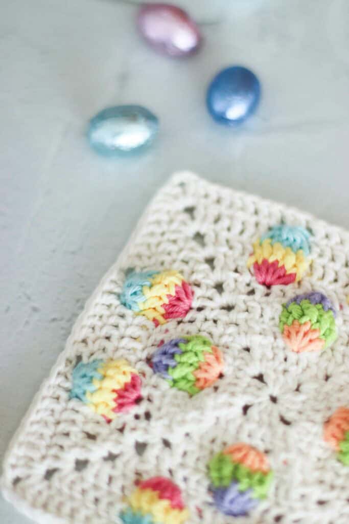 Free Easter Egg Granny Square Pattern (3D Crochet Square) crochet Easter egg granny square with raised 3D pastel eggs on cream background